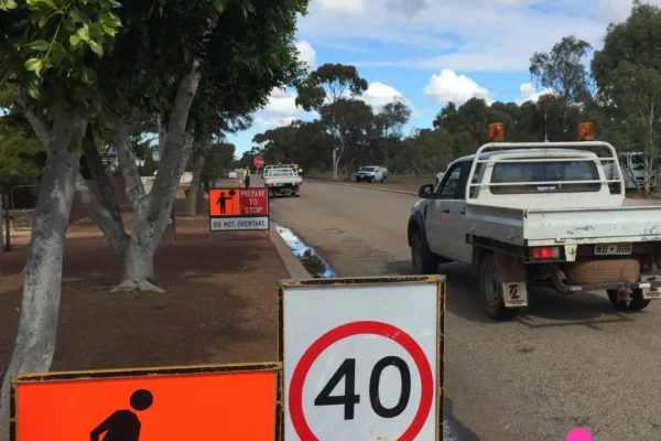 Traffic management signs and a 40 km/h speed limit set up at a mine site work zone, demonstrating road safety and traffic control measures for mining operations.