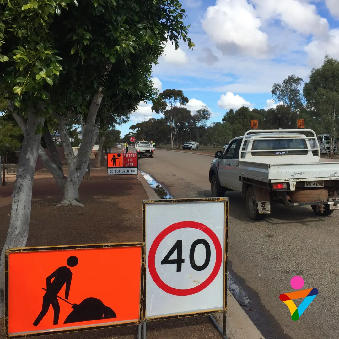 Traffic management signs and a 40 km/h speed limit set up at a mine site work zone, demonstrating road safety and traffic control measures for mining operations.