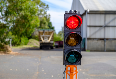 Portable traffic control device displaying a red signal light, used for practical traffic management training and worksite traffic control.
